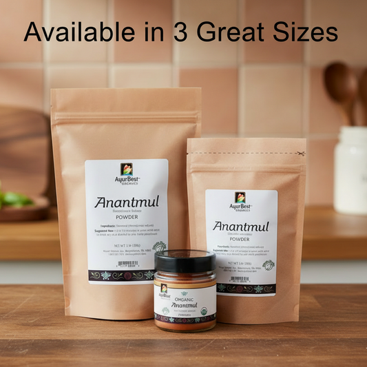 Two packages of Anantmul powder and a jar on a wooden surface with a kitchen background.