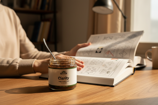 Person reading a book with a jar of 'Clarity' on a table