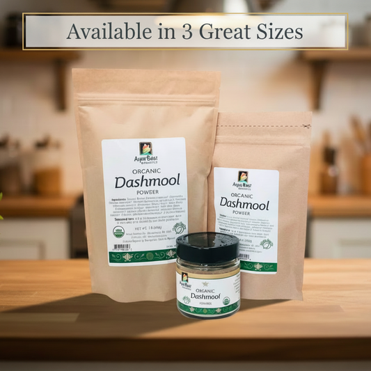 Two brown paper bags and a jar of Organic Dashmool Powder on a wooden surface with a kitchen background.