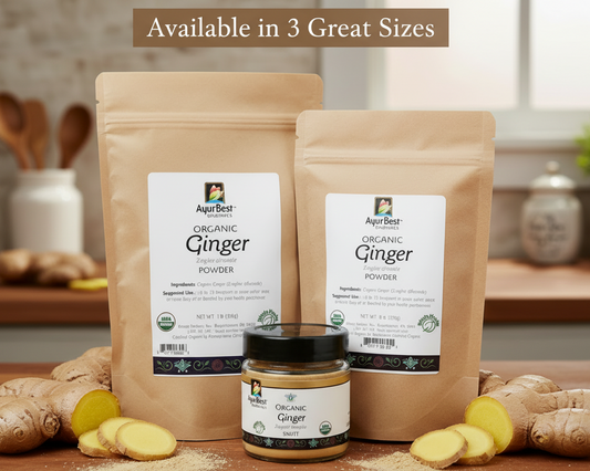 Two bags of organic ginger powder and a jar of ginger on a wooden surface with a kitchen background.