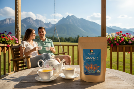 Couple enjoying tea on a wooden deck with mountains in the background, featuring a package of 'Sheetal' tea.