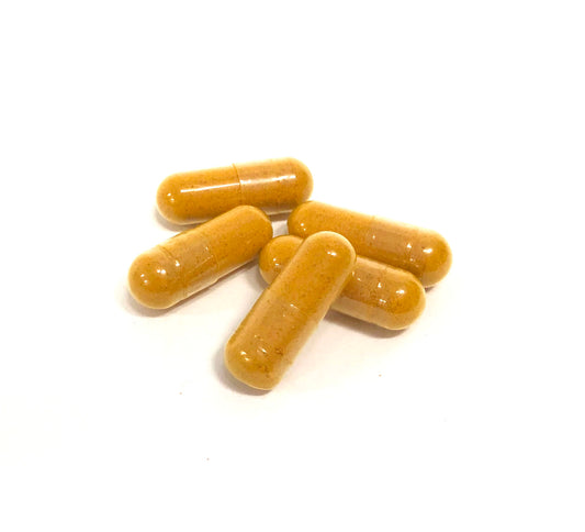 Capsules of Turmeric yellow in color on white background