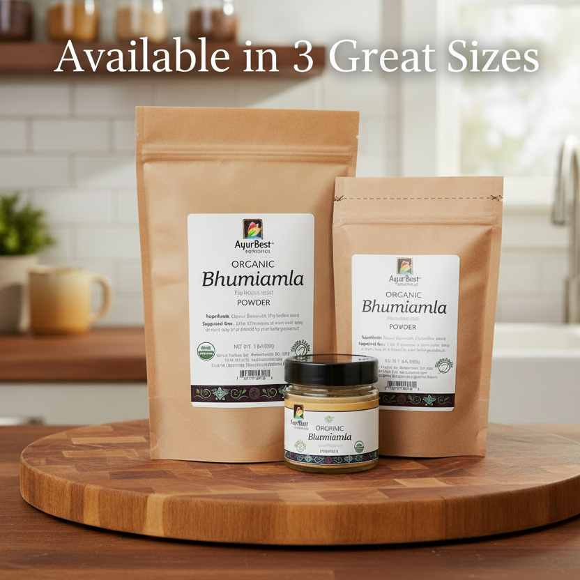 Two packages and a jar of Ajurведic Organic Bhumi Amla Powder on a wooden surface with a kitchen background.