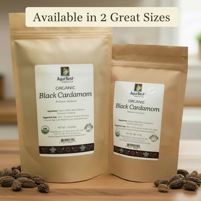 Two packages of organic black cardamom with visible labels on a wooden surface.