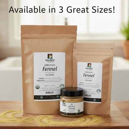 Three packages and a jar of organic fennel powder on a wooden surface with a blurred background.
