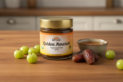 Jar of Nityam Golden Amalaki on a wooden surface with fruits