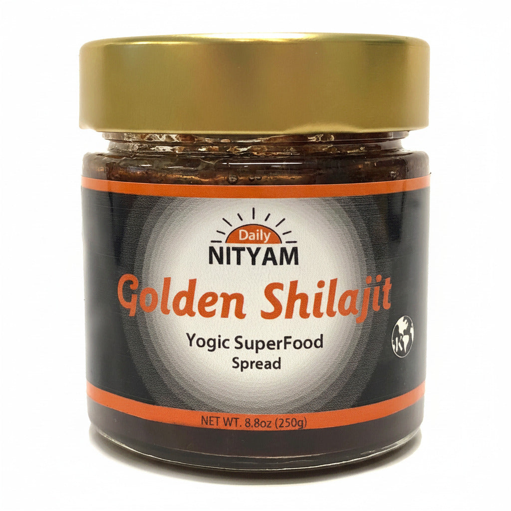 A jar of NITYAM Golden Shilajit Lehyam, Herbal Spread, with a black label and gold lid, containing visible pieces of herbs and spices.