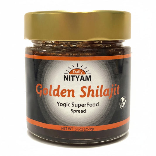 A jar of NITYAM Golden Shilajit Lehyam, Herbal Spread, with a black label and gold lid, containing visible pieces of herbs and spices.