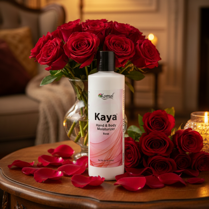 Kaya Hand & Body Moisturizer with red roses and petals on a wooden table