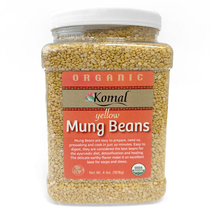 Jar of organic yellow mung beans with Komal label on a white background