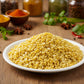 Organic  Yellow split mung dahl beans in a white bowl on a kitchen counter