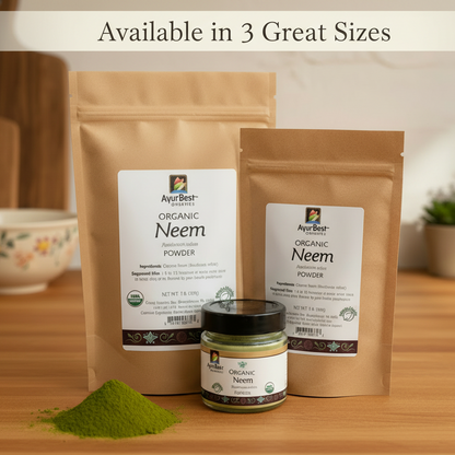 Two packages and a jar of Ayur Best Organic Neem Powder on a wooden surface.