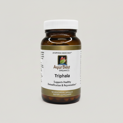 Bottle of AuurBest Organics Triphala supplement on a gray background