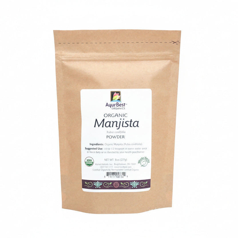A pouch of Organic Manjista Powder, with a label that includes the product name and a brief description.