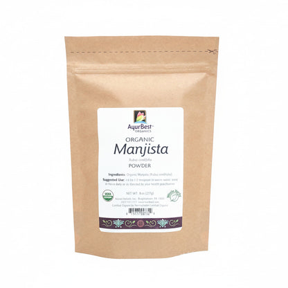 A pouch of Organic Manjista Powder, with a label that includes the product name and a brief description.